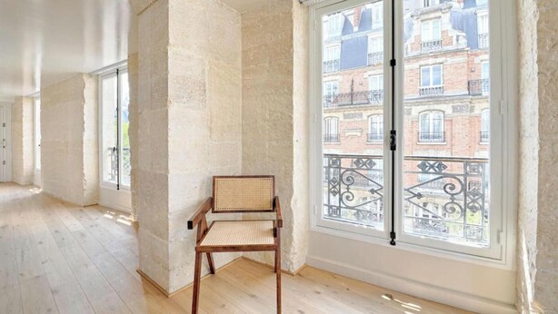 A room with a large window, a wooden floor, and a chair. - THOUGHTFULLY DESIGNED WITH CONTEMPORARY ELEGANCE NEXT TO LOUVRE -RUE SAINT DENIS (Paris)