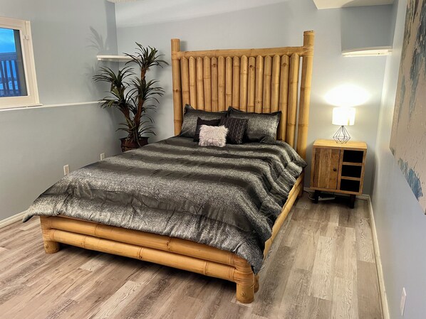A bedroom with a bed, a bedside table, a lamp, and a potted plant. - 3 BR Chantilly Oasis, Pet Friendly, Great Location (Colorado Springs)