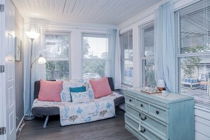 A bedroom with a bed, a dresser, and a lamp. - 3 bed/2bath home on quaint Tybee Island 2 blocks to the Beach, 1 Block to food! (Tybee Island)