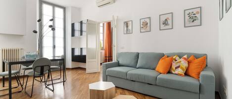 One-Bedroom Apartment | Living area | 30-inch flat-screen TV with satellite channels