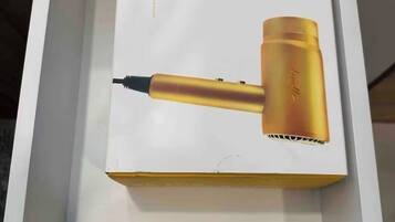 A product box for a hair dryer with the text "YOU BLOW ME AWAY" and a gold-colored hair dryer.