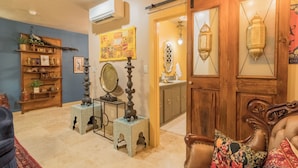 A cozy living room with a wooden door, a coffee table, and a sofa. - The Taj A Mini Taj Mahal at Downright Comfort! (Comfort)