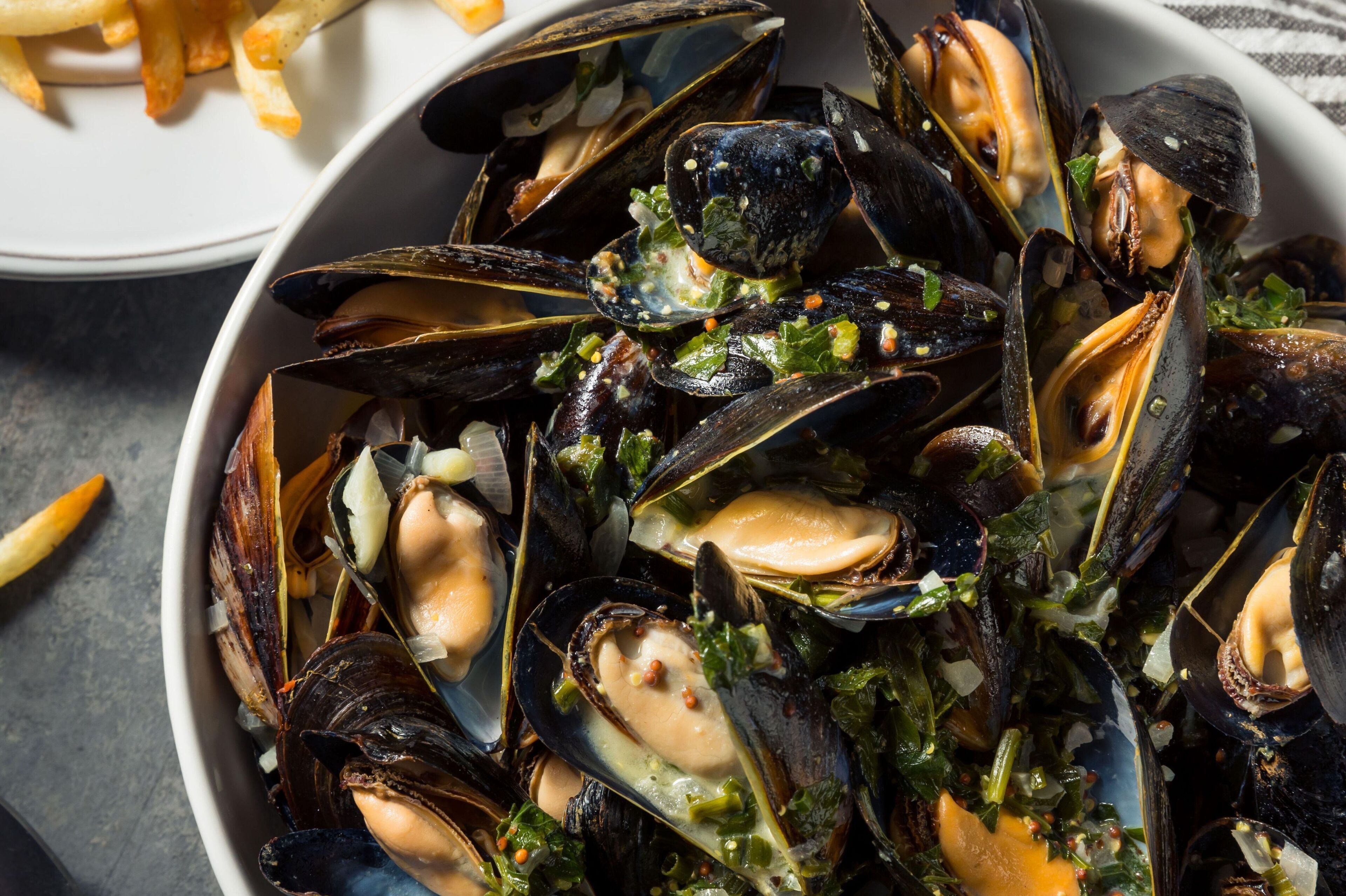A tempting bowl of freshly prepared mussels highlights the rich seafood tradition of southern Brittany.