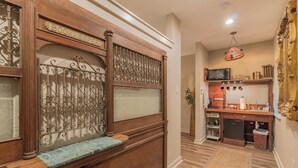 A wooden entryway with a decorative metal gate and a bench. - The Bank Vault Casita Stay at Downright Comfort (Comfort)