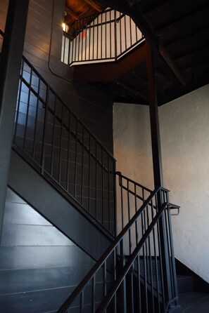 A staircase with metal railings and wooden steps.