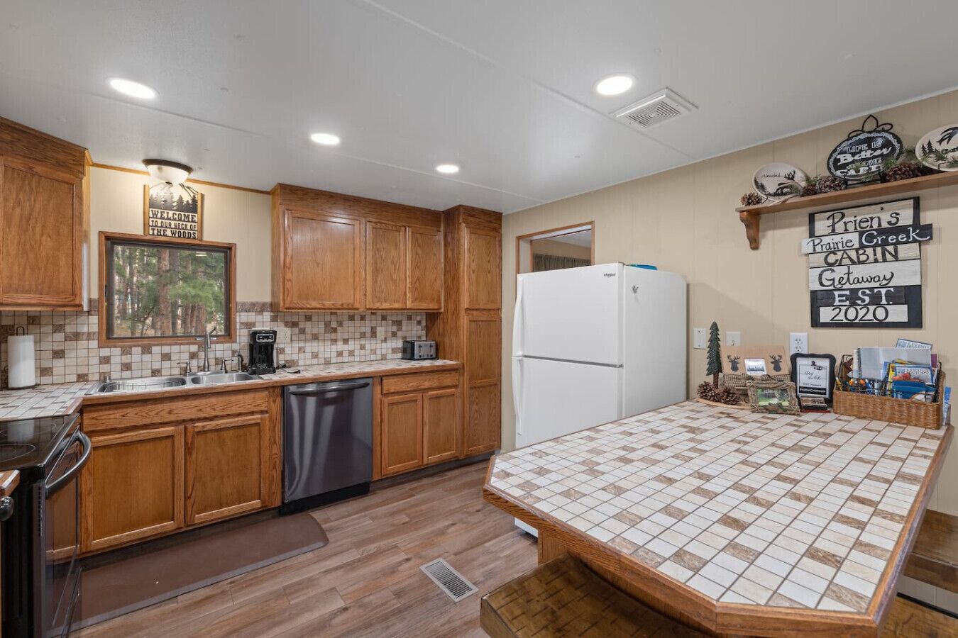 A kitchen with wooden cabinets, a white refrigerator, a tiled backsplash, and a countertop with a checkered pattern.