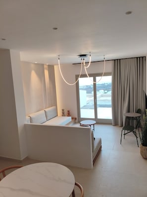 Superior Suite, Balcony, Sea View | Living area | 43-inch Smart TV with cable channels - Evira Suites (Santorini)