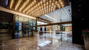 A modern lobby with a glass partition, a marble floor, and a ceiling with recessed lighting. - The Manor by Panorama Suite (Kuala Lumpur)