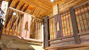 A wooden interior with a sloped ceiling, a staircase, and a door. - Barn-Again. Private Lake, Mtn view, fishing (Big Indian)