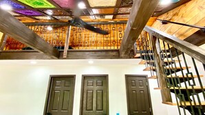 Un escalier avec une rampe en bois et une vue sur trois portes.