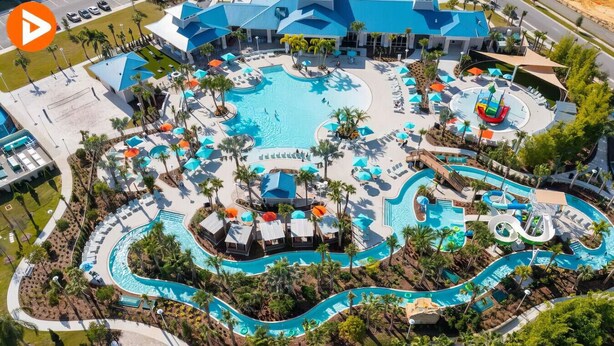 An aerial view of a resort with a large central pool, multiple smaller pools, and a water slide. - 1627 Exclusive house near Disney 5BD/15P (Davenport)