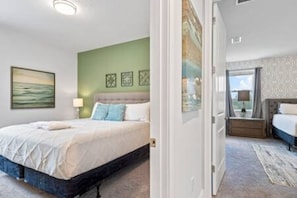 Un dormitorio con cama, mesita de noche, ventana con vistas y puerta que da a otra habitación.