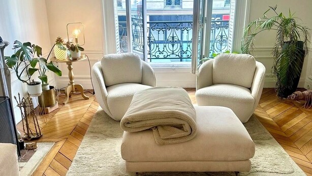 A spacious living room with a large window, two armchairs, a sofa, and a coffee table. - Beaut. Hausmannian flat in Oberkampf near Marais (Paris)
