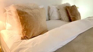 A bedroom with a bed, white bedding, and several pillows. - Beaut. Hausmannian flat in Oberkampf near Marais (Paris)