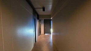 A long, narrow hallway with a tiled floor and a ceiling-mounted projector. - SSP Residence Bang Bua Thong (Bang Bua Thong)