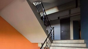 A staircase with metal railings and a handrail, leading to a landing with a door. - SSP Residence Bang Bua Thong (Bang Bua Thong)