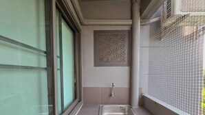 A small bathroom with a window, a sink, and a decorative panel. - SSP Residence Bang Bua Thong (Bang Bua Thong)