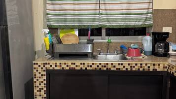 Coffee/tea maker, microwave, cookware/dishes/utensils, spices