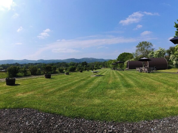 A well-maintained lawn with a picnic area, a covered structure, and a view of distant hills. - Primrose (Malvern)