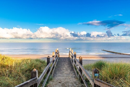 Single-storey beachlodge close to the sea, with fenced terrace and awning.