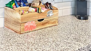 A kitchen with a wooden crate filled with coffee products, a Keurig coffee maker, and a white tiled backsplash. - 4 Bedroom / 4.5 Bathroom, Unit B_ Newly Built - Med Center / NRG / Downtown / UH (Houston)