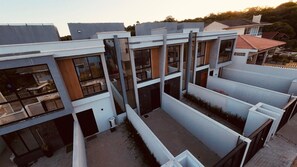 A modern building with multiple balconies and large windows. - Sobrado 03 (Florianópolis)