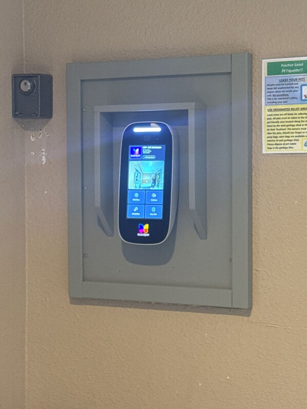 A wall-mounted intercom system with a screen displaying a map and control buttons.