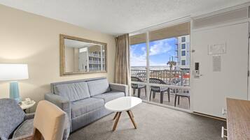 Deluxe Room, Ocean View | Living area | 32-inch TV with cable channels