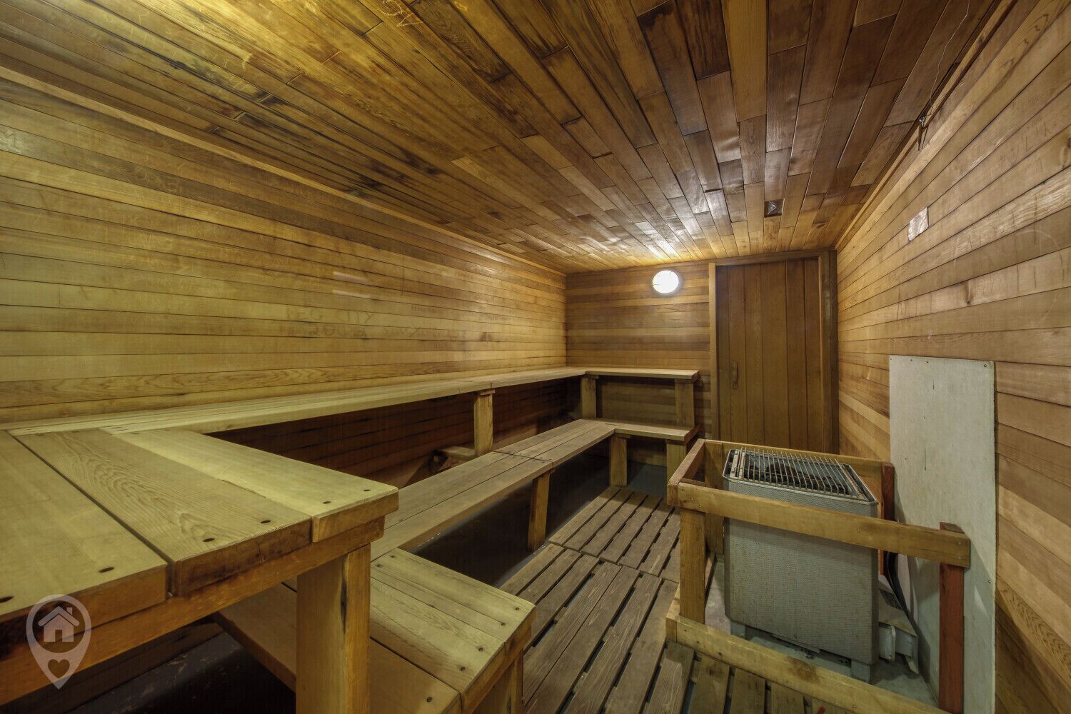 A wooden sauna with benches and a bench seat.