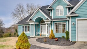 A two-story house with a front porch, a garage, and a landscaped front yard. - Boone Lake Getaway 6 Mi to Bristol Speedway! (Piney Flats)