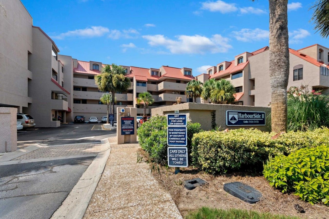 A multi-story residential building with a sign indicating it is HarbourSide II.