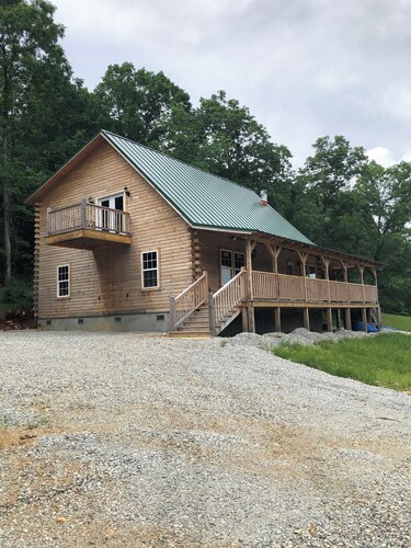 Cedar log cabin overlooking spring-fed ponds with waterfalls at Wautauga Springs