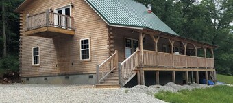 Cedar log cabin overlooking spring-fed ponds with waterfalls at Wautauga Springs