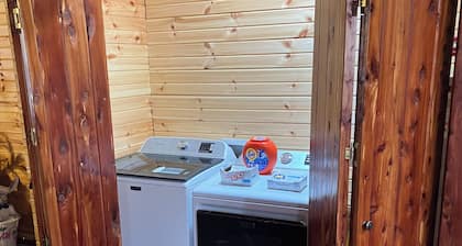 Cedar log cabin overlooking spring-fed ponds with waterfalls at Wautauga Springs
