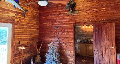 Cedar log cabin overlooking spring-fed ponds with waterfalls at Wautauga Springs