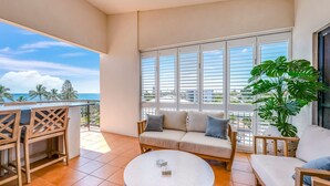 A balcony with a sofa, chairs, and a coffee table. - Bargara Coastal Escape – Modern 3 Bedroom Penthouse with Sea Views (Bargara)