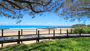A wooden boardwalk leading to a beach with clear skies and ocean views. - Bargara Coastal Escape – Modern 3 Bedroom Penthouse with Sea Views (Bargara)