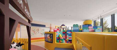 A children's play area with colorful building blocks, a slide, and a cow-shaped play structure.