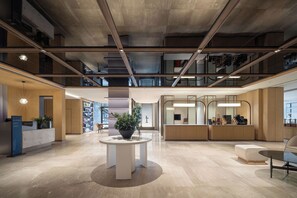 A spacious lobby with a reception desk, seating area, and a large potted plant. - Holiday Inn Express Huangshan Mountain South Gate By Ihg (Huangshan)