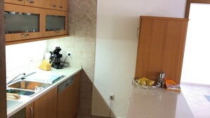 A kitchen with wooden cabinets, a sink, and a countertop. - Istrian Family Villa Shopacita - family, bike & pet friendly<3 (Tar)