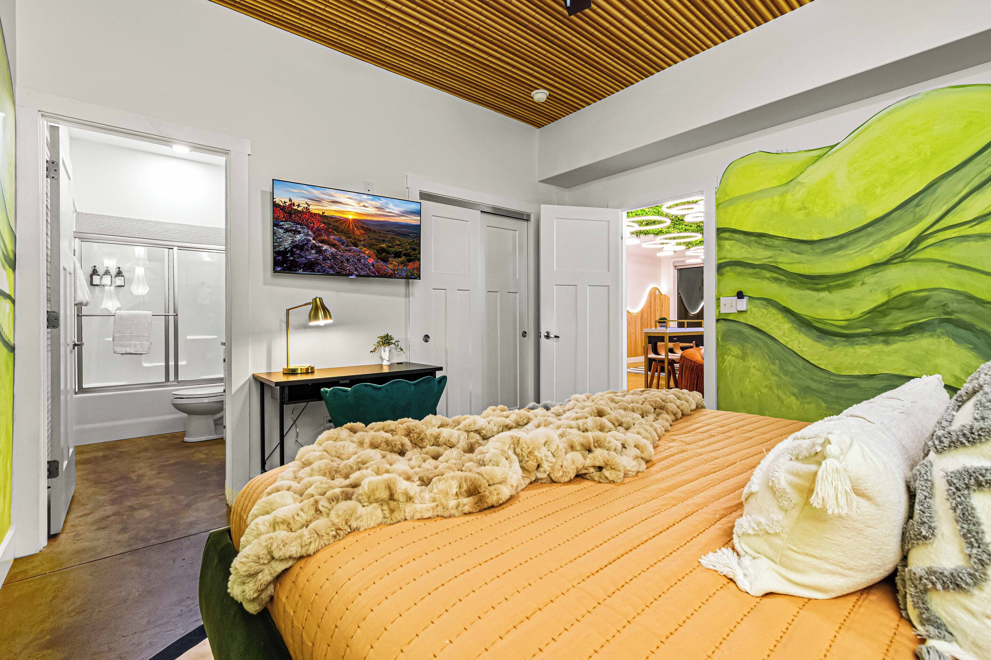 Moody master bedroom has a plush king bed, private ensuite bathroom & workspace!