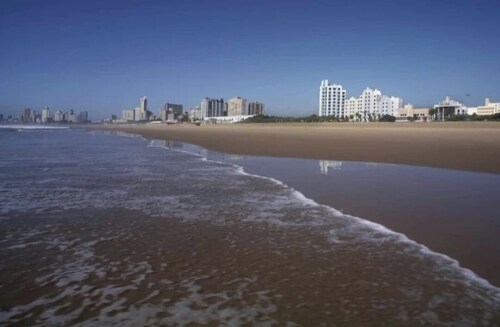 Beautiful apartment with AC in vibrant Durban in secured complex with pool.