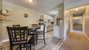 A compact kitchen with white cabinets, a microwave, and a sink. - Panoramic Mountain Views, Sauna, Pet Paradise (Fernie)