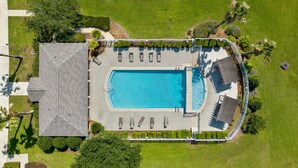 An aerial view of a swimming pool area with a rectangular pool, sun loungers, and a covered seating area. - Park Avenue 813 - Heart of Foley (Foley)
