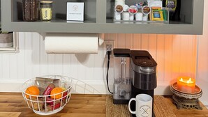 A kitchen with a wooden basket, jars, a coffee maker, and a candle on the counter. - Farm Stay Near Town - Animals, Fire Pit, & Privacy - close to wedding venues (Georgetown)