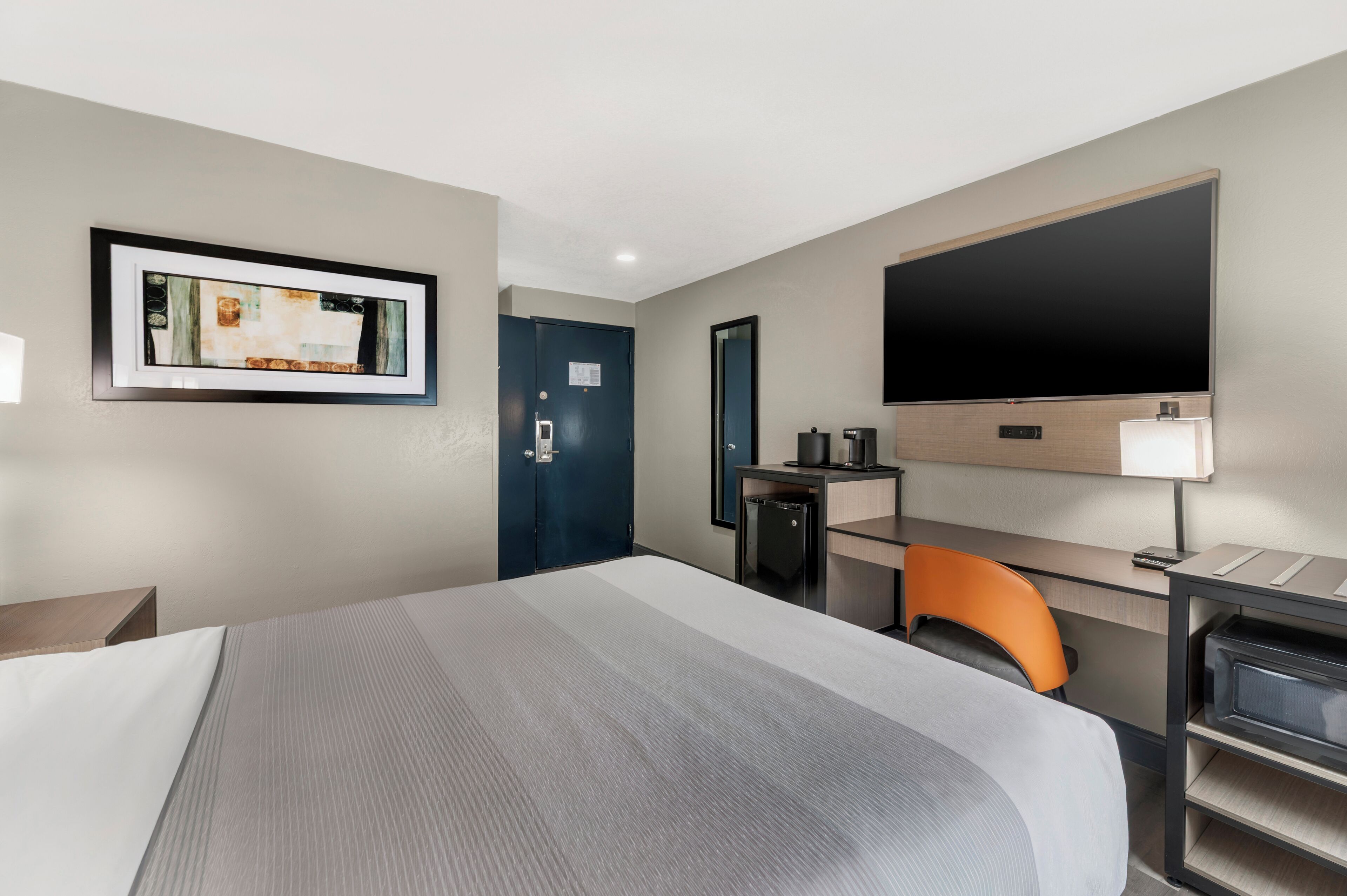 Premium bedding, desk, laptop workspace, blackout drapes