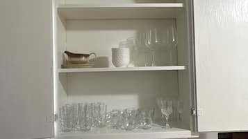 A kitchen with a white cabinet, a sink, and a countertop.