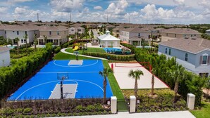 A residential area with a basketball court, houses, and a swimming pool. - The GemStone Retreat (Kissimmee)