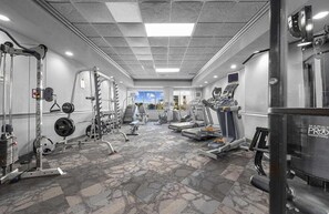 A gym with weightlifting equipment, treadmills, and cardio machines. - Bluewater 821 (Myrtle Beach)