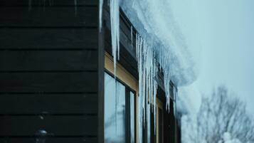A wooden building with icicles hanging from the roof.